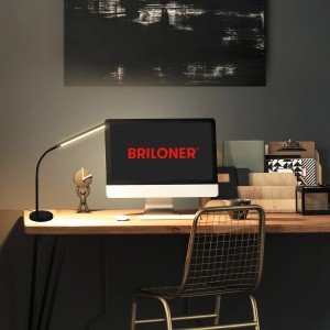 Schwarze Brilo LED-Tischleuchte Pivaz mit Touch-Dimmer und warmweißem Licht auf Schreibtisch.