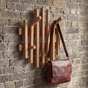 MCA Garderobenpaneel P57 aus Eiche Massivholz mit 4 Haken und einer braunen Tasche.
