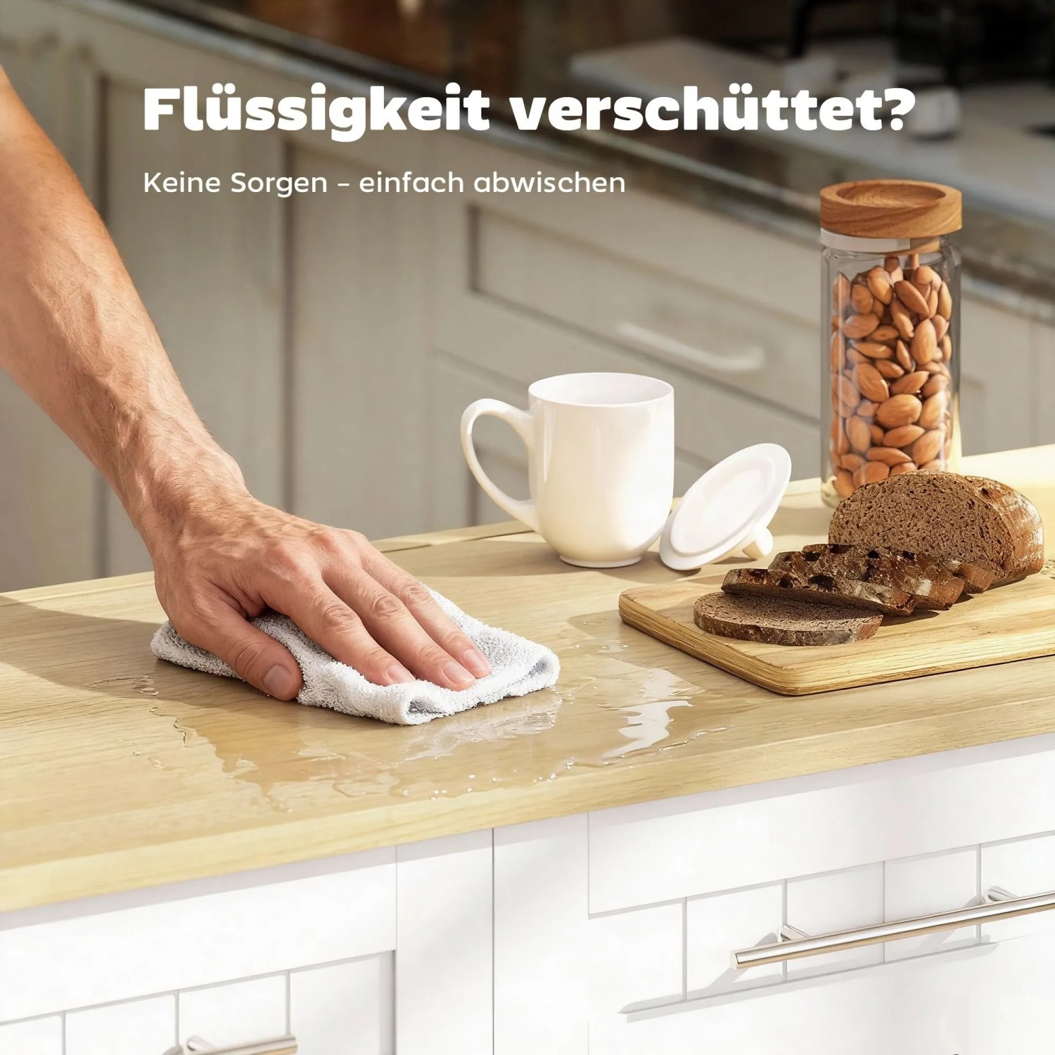Hand wischt verschüttete Flüssigkeit von heller Kücheninsel-Arbeitsplatte. HOMCOM Kücheninsel, leicht zu reinigen.