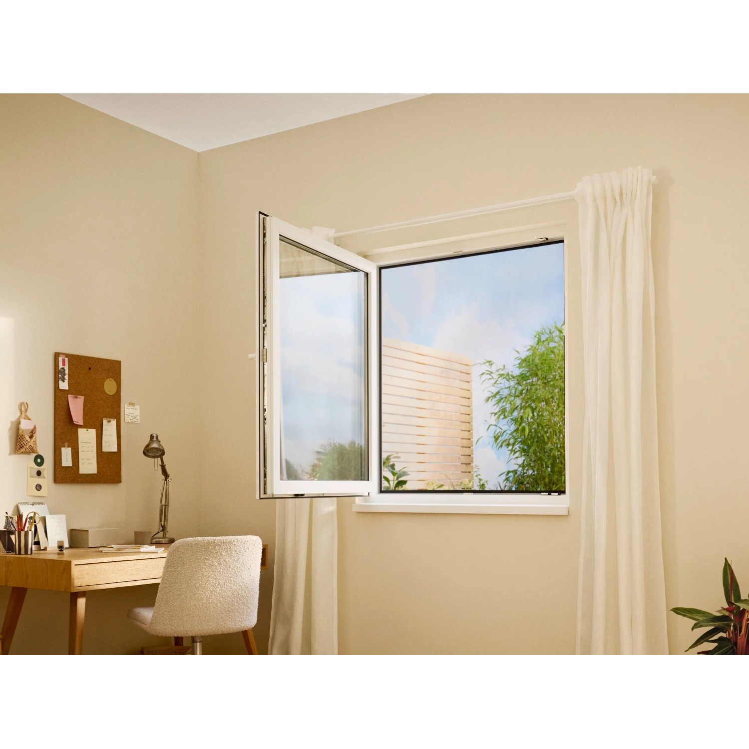Geöffnetes Fenster mit anthrazitfarbenem tesa® Insect Stop Fliegengitter Premium.