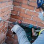 Bosch Diamant-Dosensenker (82mm) im Einsatz an einer Ziegelwand mit einem Bohrhammer.