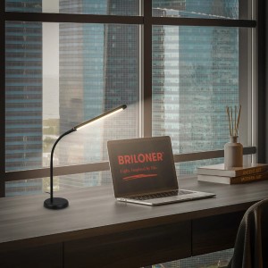 Schwarze Brilo LED-Tischleuchte Mura, schwenkbar und dimmbar, auf einem Schreibtisch.