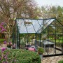 Halls Gewächshaus Garden Room, 12,9 m², grüne Aluminiumstruktur mit Sicherheitsglas im Garten.