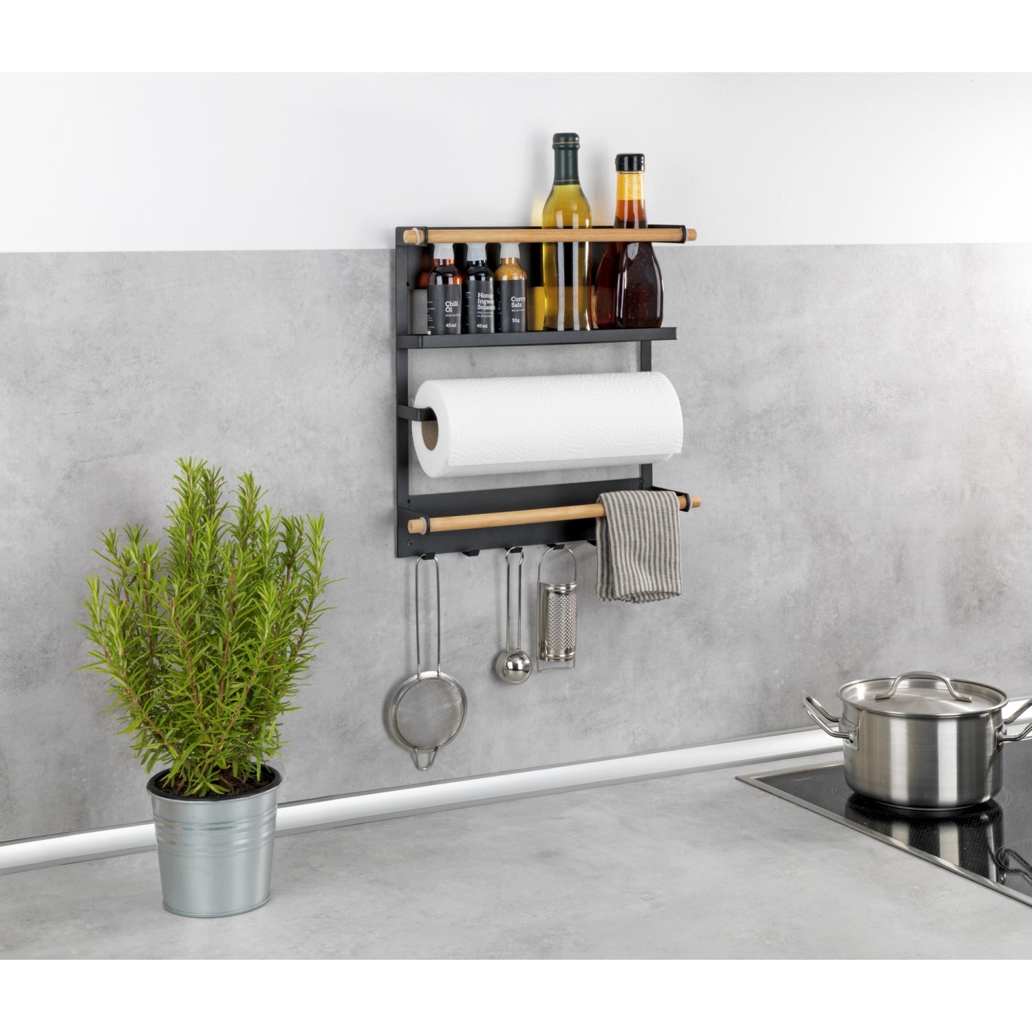 Wenko Küchenregal Magna Schwarz mit Küchenutensilien und Papierrolle.