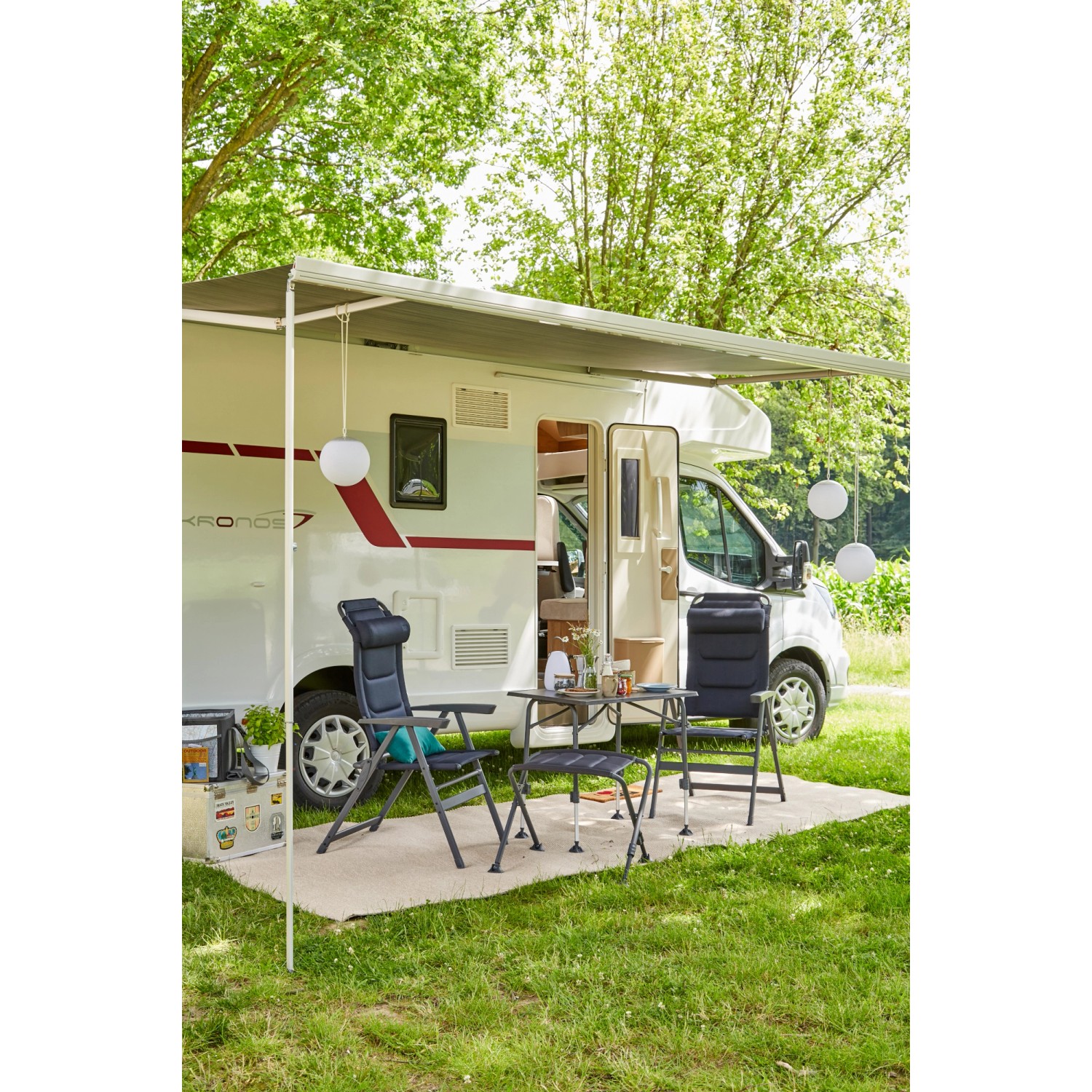 Siena Garden Campingsessel Premium, dunkelblau, vor Wohnwagen auf Rasen. Bequemer Klappstuhl für Camping.