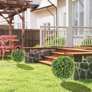 Zwei HOMCOM künstliche Buchsbaumkugeln auf grünem Rasen vor einem Haus. Perfekte Gartendekoration als Kunstpflanze.