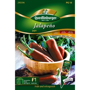 Quedlinburger Jalapeno Japo Saatgut: Reife, rote und grüne Chili in Holzschale.