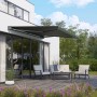 Anthrazit Halbkassettenmarkise Maraca 4x2,5m mit Solarpanel am Haus, darunter Gartenmöbel.