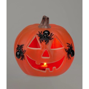 Oranger Halloween-Kürbis mit leuchtendem Gesicht und drei schwarzen Spinnen. Dekorative Figur für Halloween.