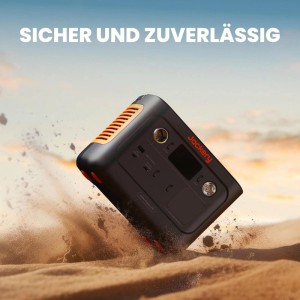 Jackery Powerstation E240 v2 Stromerzeuger in Schwarz-Orange auf Sand.
