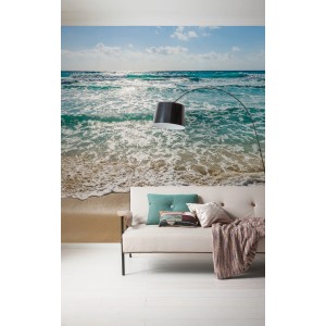 Komar Vlies Fototapete Seaside (300x250 cm) mit Strand- und Meeresmotiv im Wohnraum.