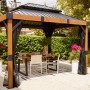 Sojag Pavillon Fontana 289x363 cm mit Moskitonetz und Esstisch im Garten.