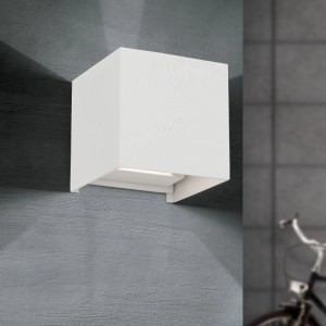 Weiße, quadratische Orion LED Außen Wandleuchte aus Aluminium an grauer Wand. Einstellbarer Abstrahlwinkel, warmweißes Licht.