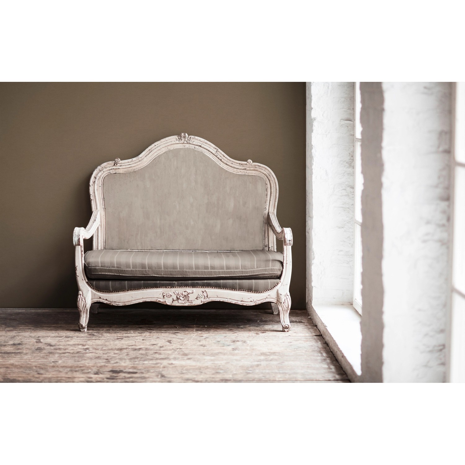 Braune Wand mit Vliestapete Uni Matt leicht strukturiert hinter antikem Sofa.