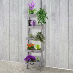 Graues MCW Pflanzregal/Blumenständer mit 5 Ablagen in Schubladenoptik und diversen Pflanzen.