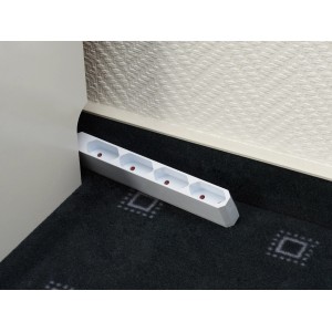 Weiße Euro-Steckdosenleiste mit 4-fach Anschluss auf Teppichboden, geeignet für den Innenbereich.