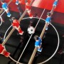 Detailaufnahme: Tischfußball-Aufsatz des roten Axi Kühlwagens mit Spielfiguren und Ball.