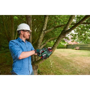 Mann sägt Ast mit Bosch Akku-Kettensäge UniversalChain 18V. Inkl. Akku. Für Gartenarbeiten.