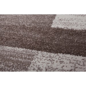 Detailansicht des beigen Kayoom Teppichs Falkland Port Louis mit meliertem Patchwork-Design.