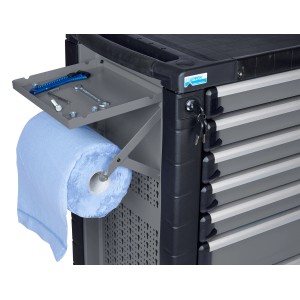Küpper Papierrollenhalter, hellgrau, an Werkbank montiert, mit Papierrolle, Ablagefach und Werkzeugen.