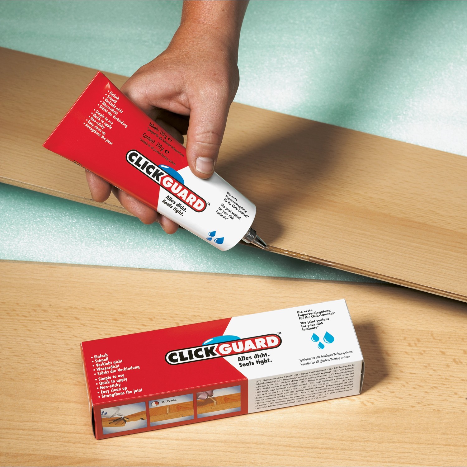 Clickguard Fugenversiegelung für Parkett und Laminat in Anwendung, mit Produktverpackung.