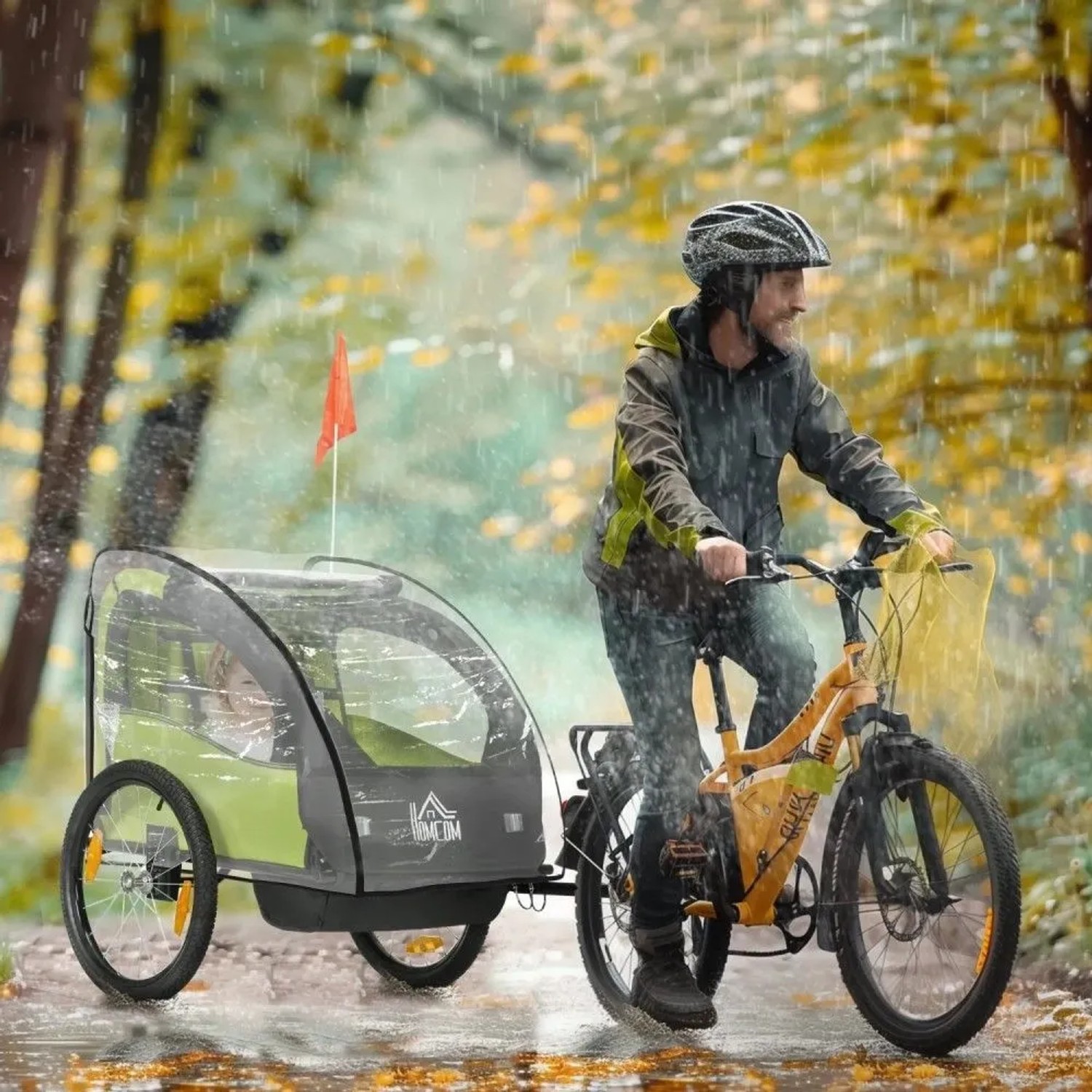 HOMCOM Regenschutz für Kinderfahrradanhänger, transparent, schützt vor Regen. Ein Radfahrer mit Anhänger im Herbstwald.