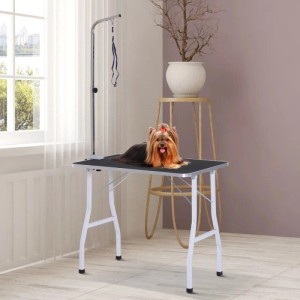 PawHut Hundepflegetisch schwarz mit weißen Beinen, verstellbarem Arm und blauen Schlingen. Yorkshire Terrier auf dem Trimmtisch zur Fellpflege.