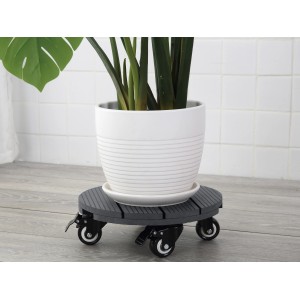 Runder, geriffelter Pflanzenroller aus WPC in Anthrazit mit Pflanze im Topf.