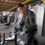 Mann schneidet Metall mit Bosch Professional Akku-Stichsäge GST 18 V-125 S. Blaue kabellose Stichsäge im Werkstatt-Einsatz.