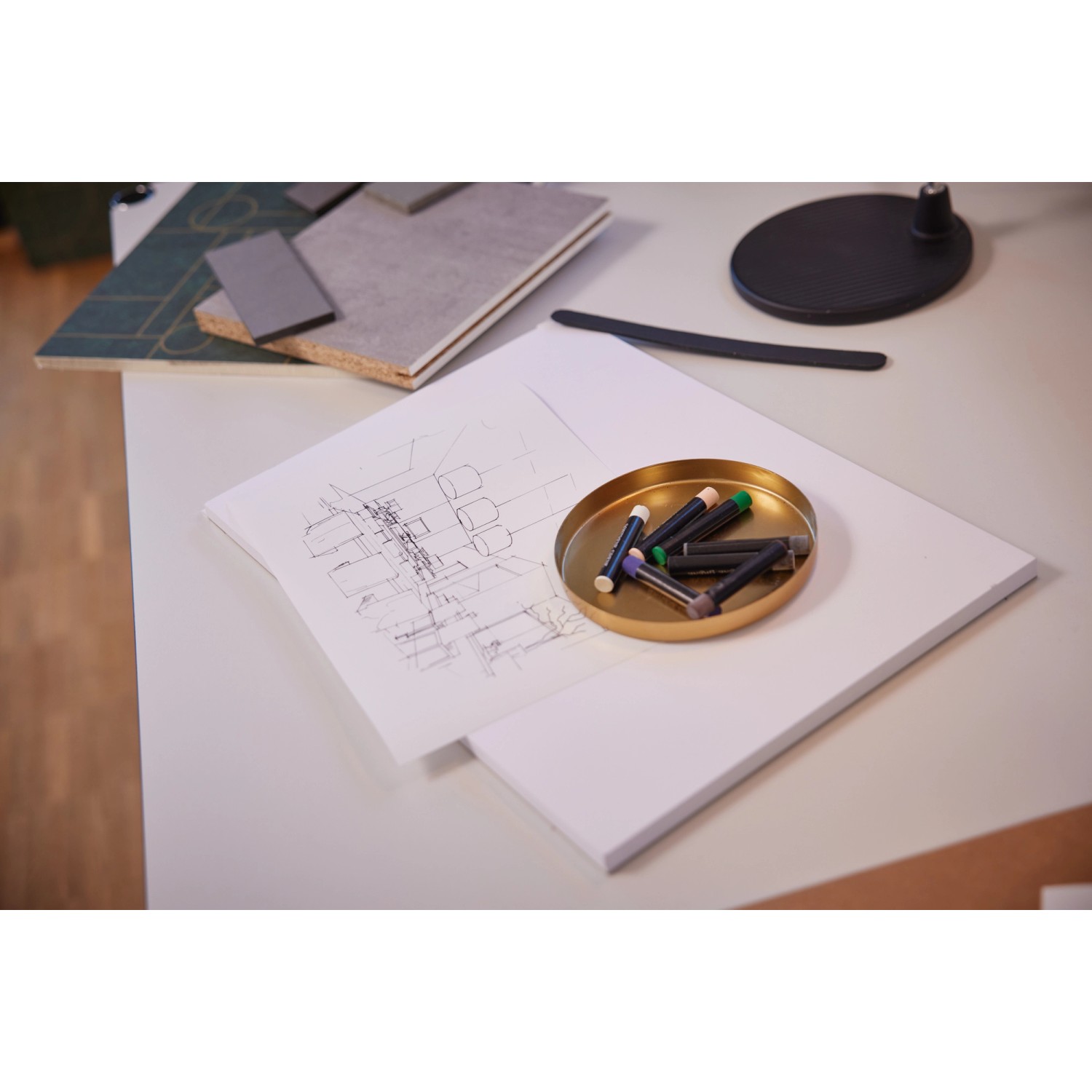 Mustertisch mit Vliestapete in Opalgrün und Gold, geometrisches Design.