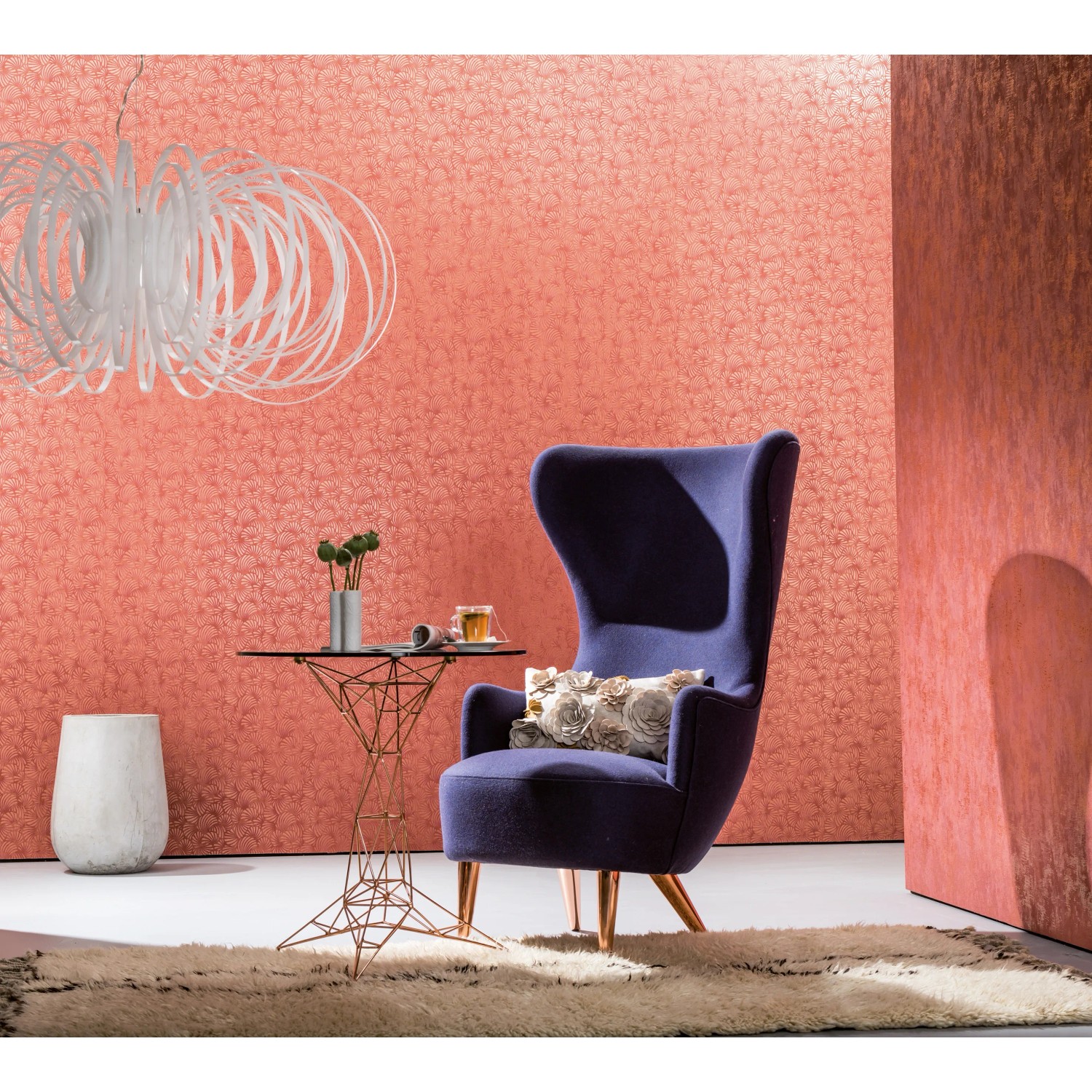 Wohnraum mit Vliestapete Nabucco Uni in Rot-Kupfer, Sessel und Beistelltisch.