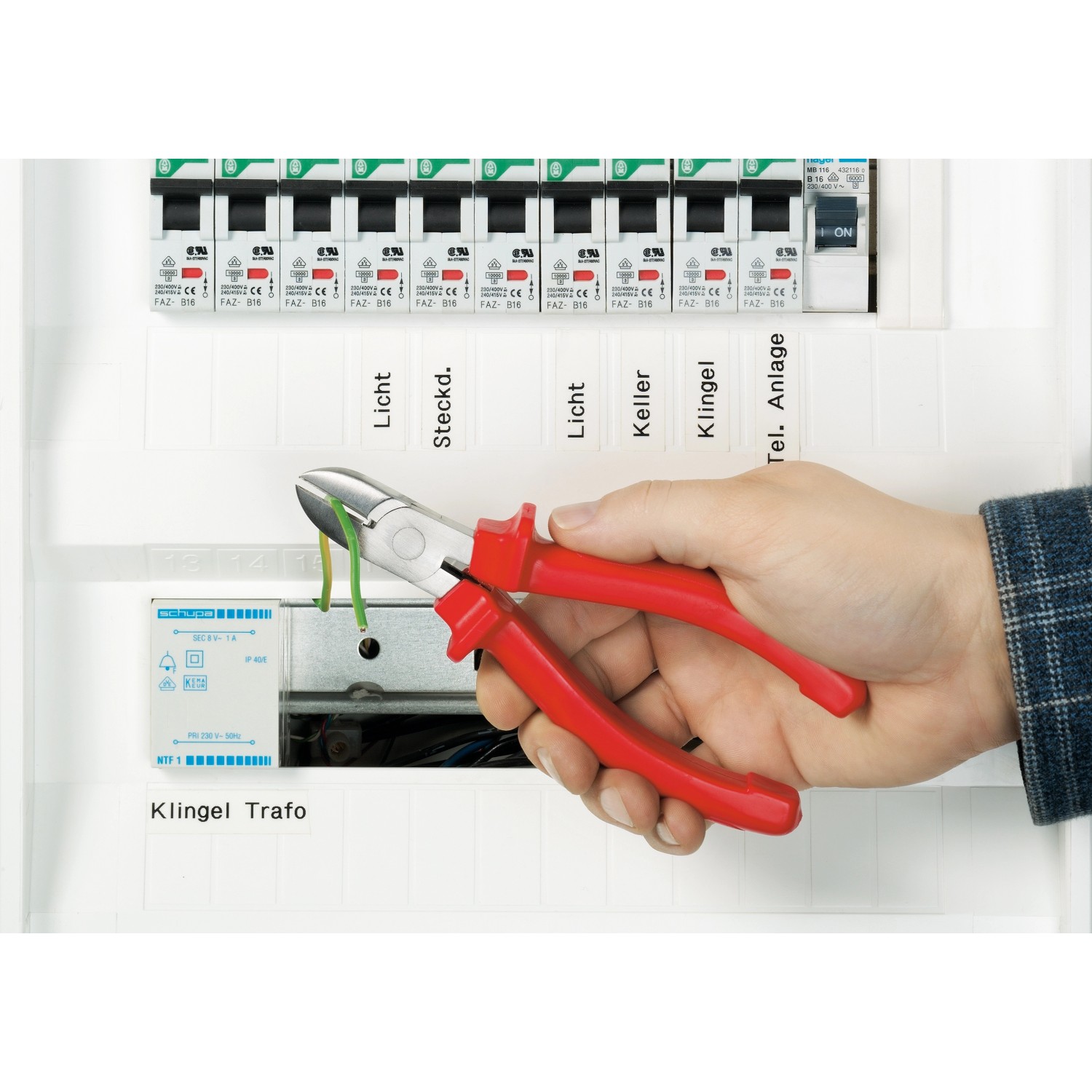 Ellix Zangen Set, 3-teilig, im Einsatz zum Schneiden eines Kabels vor einem Sicherungskasten.