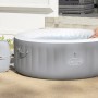 Bestway Lay-Z-Spa St. Lucia AirJet aufblasbarer Whirlpool in Grau mit Frau im Wasser.