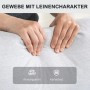 Hände drücken in hellgrauen Relaxsessel-Stoff mit Leinen-Look. Atmungsaktives, abriebfestes Polyestergewebe.