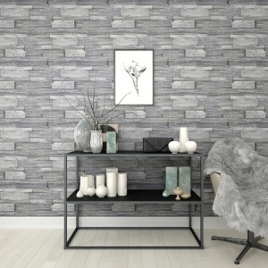 Superfresco Easy Vliestapete Stone Wall Grey imitiert eine graue Steinwand im Raum.