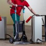Mann nutzt wolfcraft Sackkarre TS 1500 zum Transport eines Geräts. Klappbare Baukarre mit großer Schaufel.