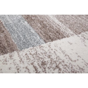 Kayoom Kurzflorteppich Falkland Darwin in Pastellblau mit meliertem Muster und Patchwork-Rahmen.