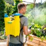 Mann nutzt Gloria Rückensprüher Hobby 1200 (6 bar) zur Pflanzenpflege im Garten.