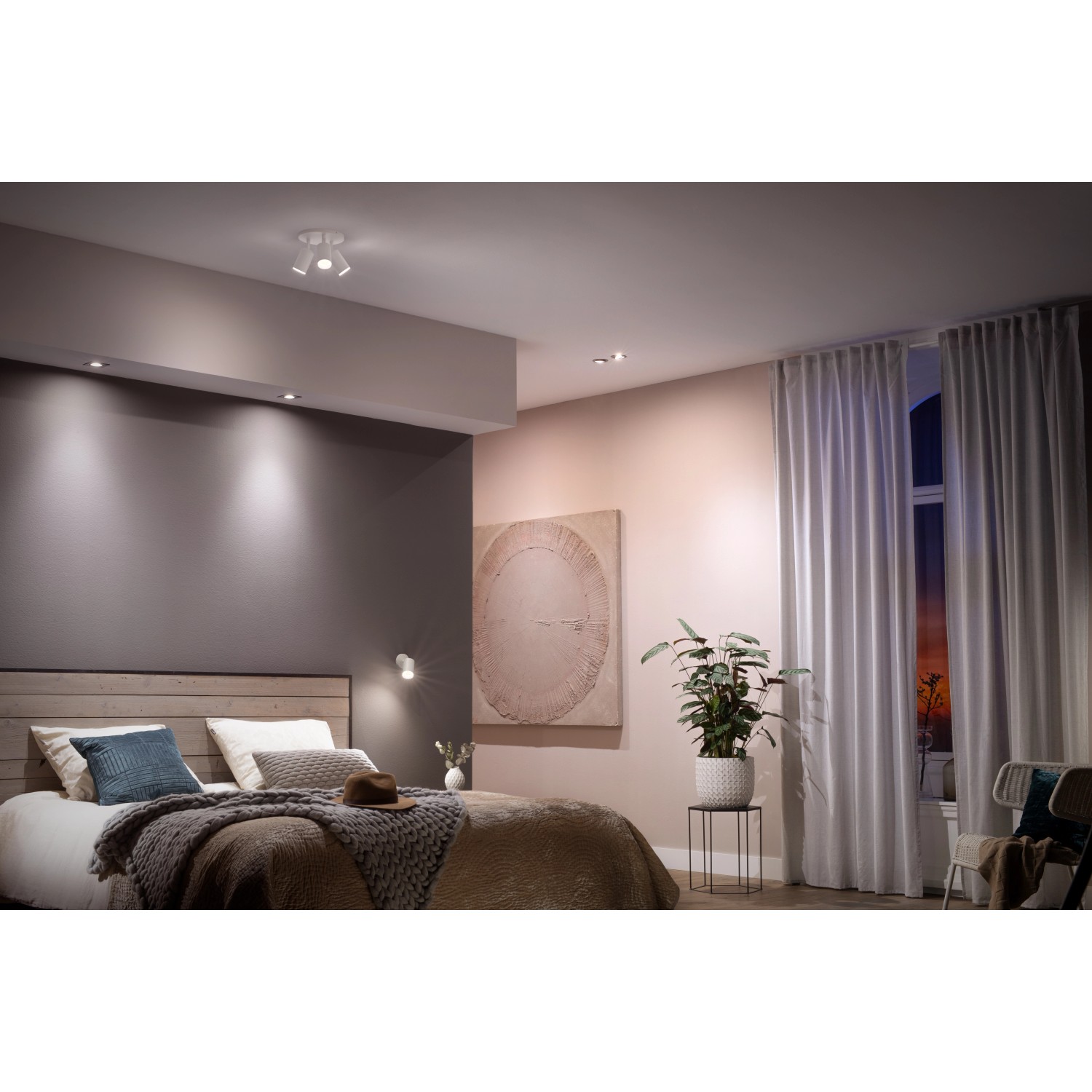 Philips Hue LED-Spot GU10 Doppelpack in einem Schlafzimmer mit Bett und Vorhängen.