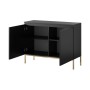 Schwarzes Selsey Sideboard Bemmi mit goldenen Beinen, offene Tür zeigt 4 Fächer. Griffloses, modernes Design.