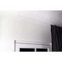 Weiße, minimalistische 1-Lauf Gardinenschiene zur Deckenmontage über einem Fenster mit dunklem Vorhang. Dekoartikel.