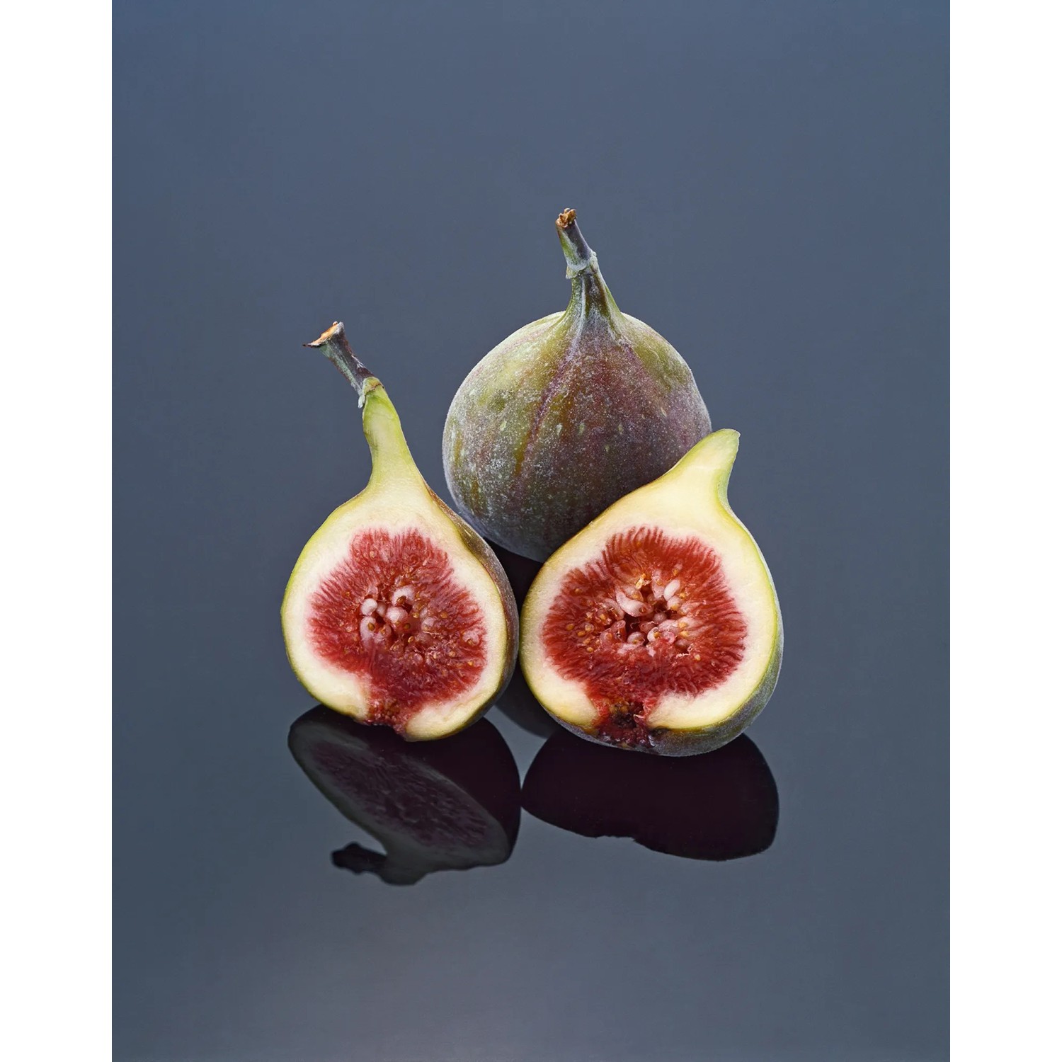 Drei Feigen, davon zwei halbiert, zeigen das rote Fruchtfleisch. GROW by OBI Echte Feige.