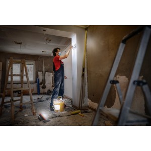 Handwerker mit Ledvance LED-Baustrahler akkubetrieben bei Renovierungsarbeiten im Innenraum.