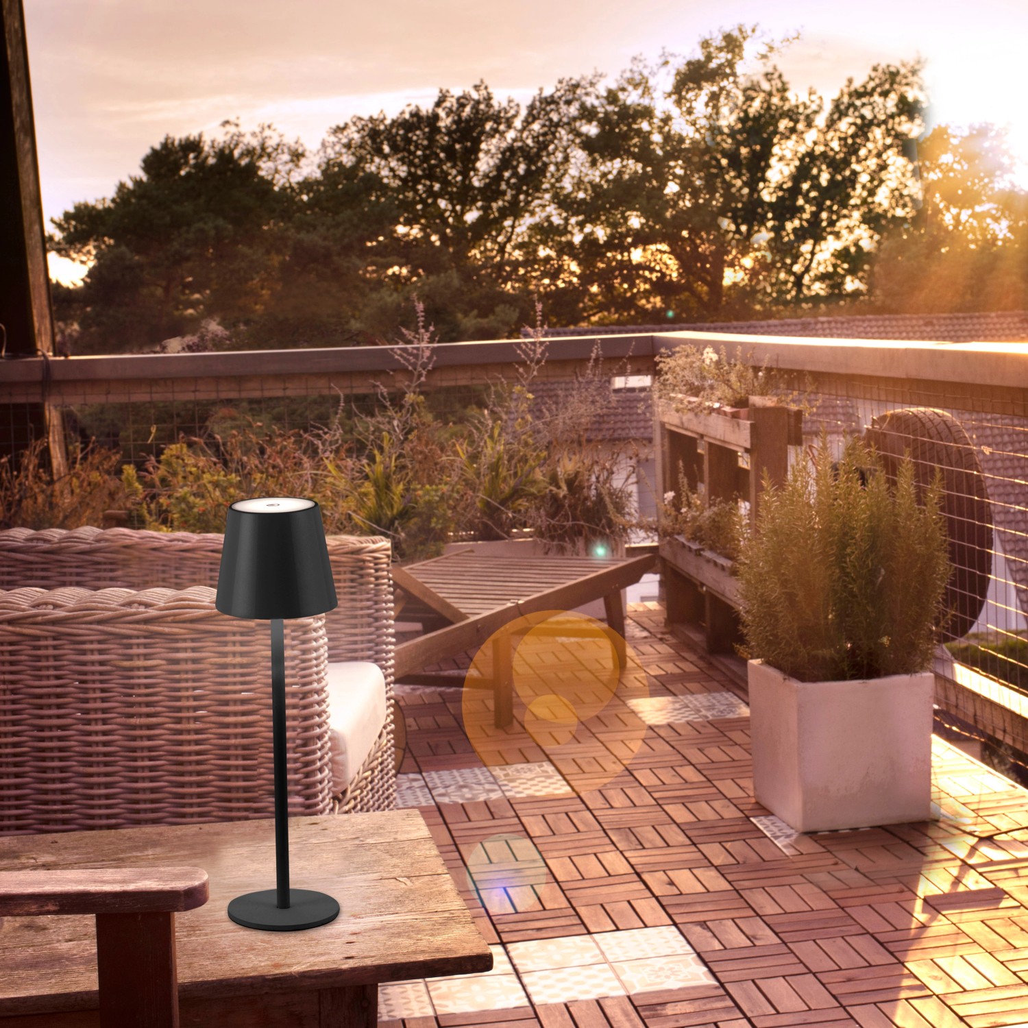Schwarze LED-Akku-Tischleuchte Euria von Just Light, 37 cm hoch, auf einem Holztisch im Außenbereich.