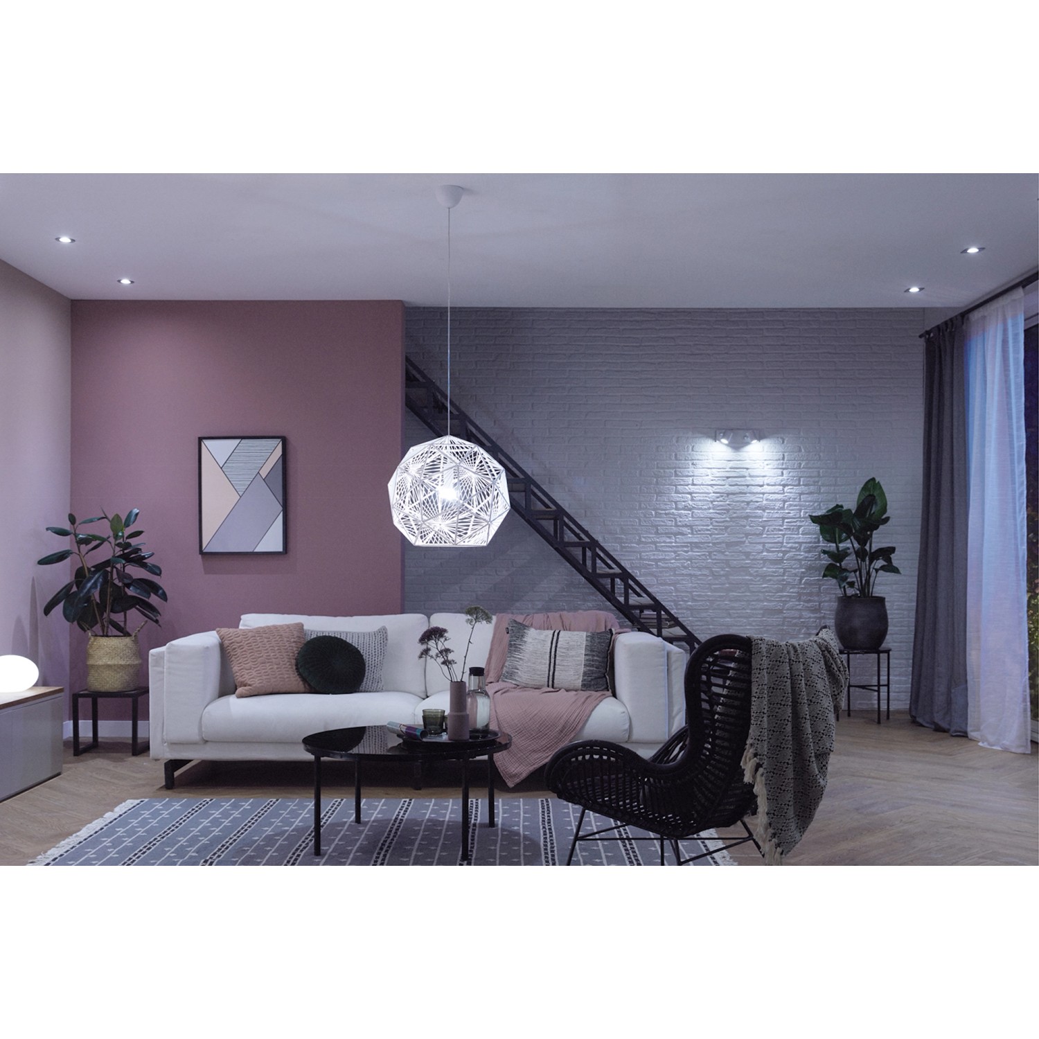 Wohnzimmer mit Philips Hue White Ambiance E27 LED Lampe (2er-Pack) unter einer dekorativen Hängelampe.