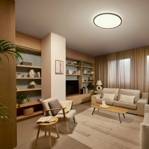 Philips Valen LED-Deckenleuchte, schwarz, 55 cm, rund, leuchtet ein modernes Wohnzimmer warm aus.