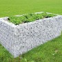Gabionen-Hochbeet (200x100x80 cm) mit Steinfüllung und Bepflanzung im Garten.