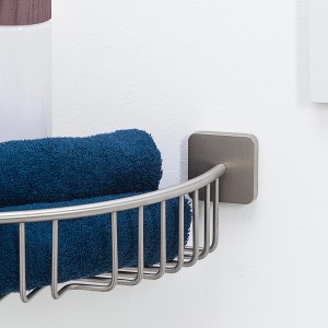 Eck-Duschablage Onu von Tiger aus gebürstetem Edelstahl mit blauem Handtuch.