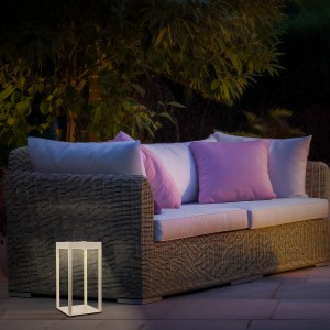 Beige Brilo LED Laterne Luca, dimmbar und spritzwassergeschützt, neben einer Gartenlounge.