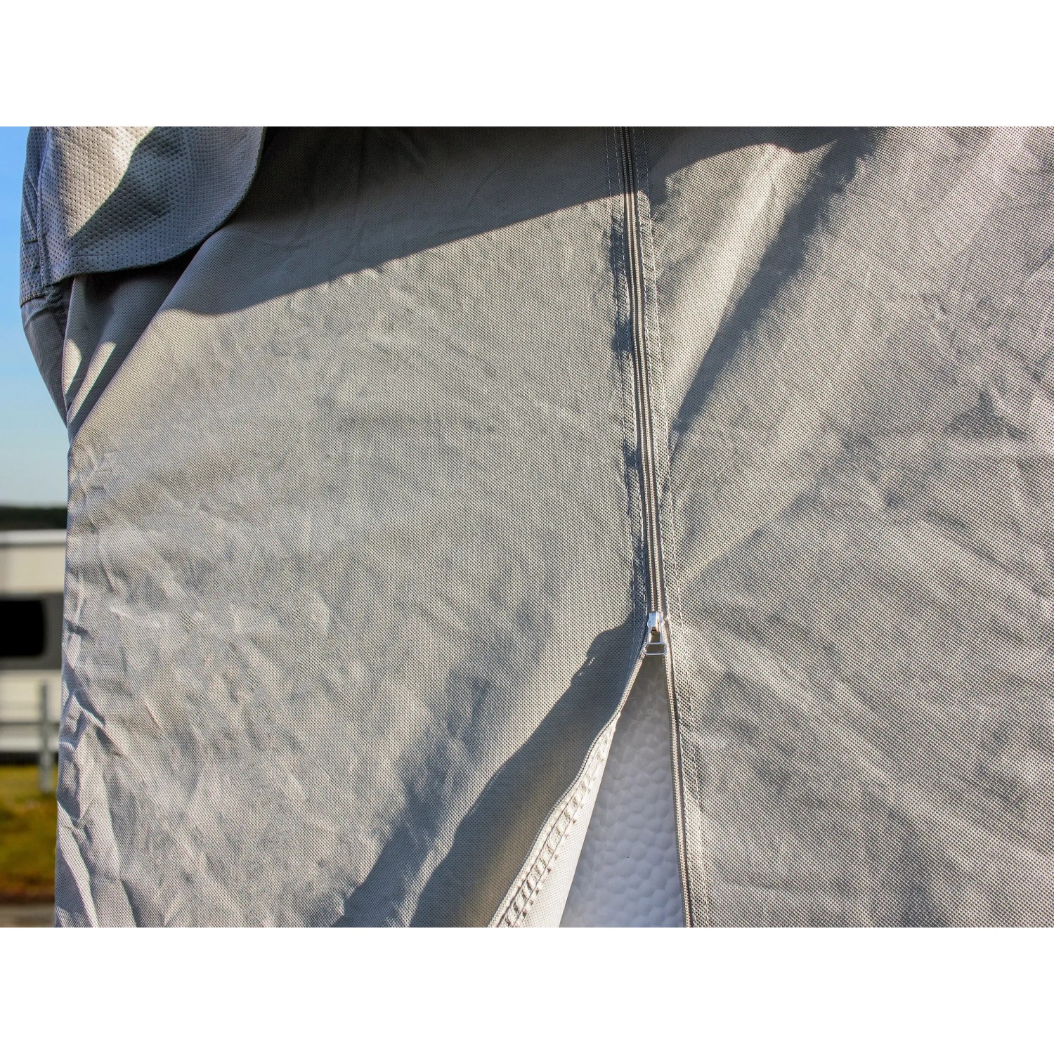 Detailaufnahme: Graue Wohnmobil-Schutzhülle (750x235x270 cm) mit Reißverschluss.